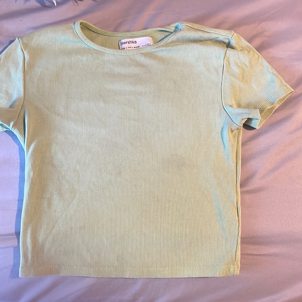 A tight light green top in small from the brand Bershka